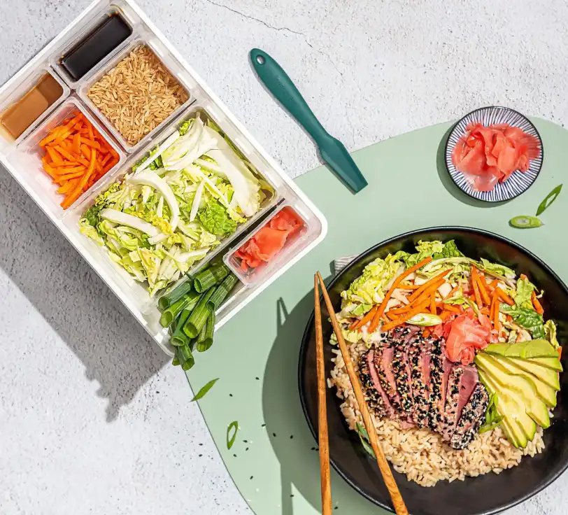 A Fresh Prep meal kit tray with sorted ingredients beside the finished seared tuna rice bowl